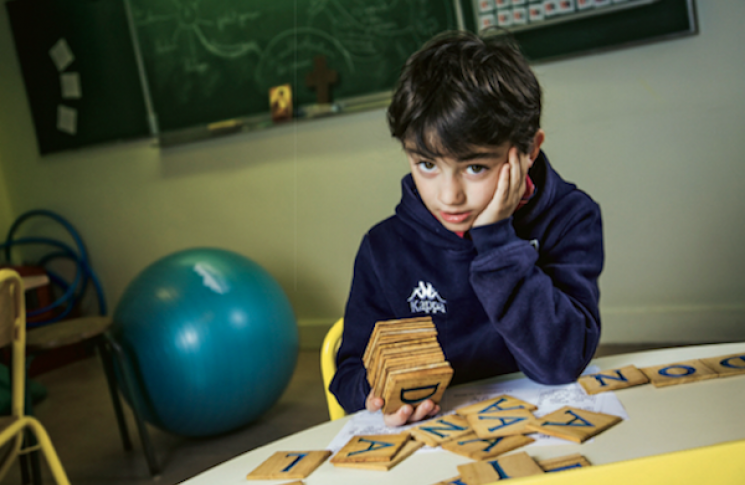 Un enfant perdu face aux lettres de l’alphabet