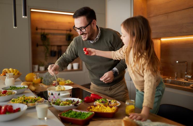 père et fille préparant la nourriture dans la cuisine.
